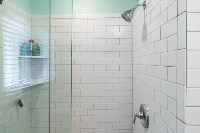 bathroom with a tile shower