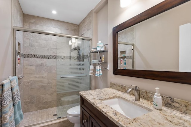 bathroom with vanity, toilet, and walk in shower