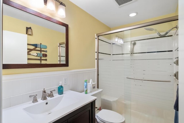 bathroom with vanity, toilet, and an enclosed shower