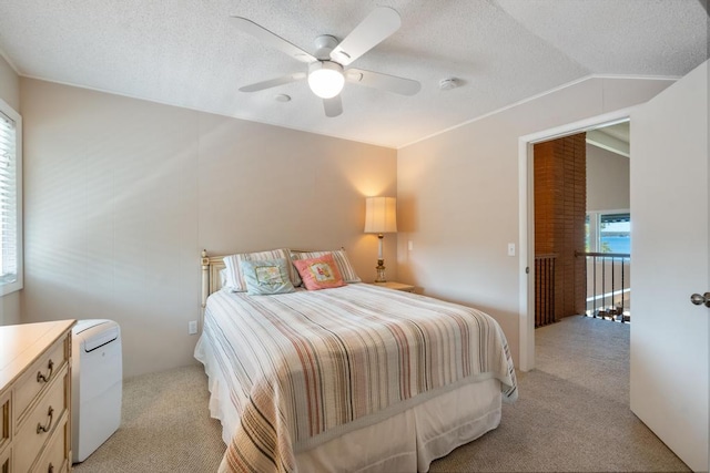 bedroom featuring light carpet, multiple windows, ceiling fan, and lofted ceiling