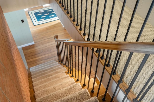 stairway with hardwood / wood-style flooring