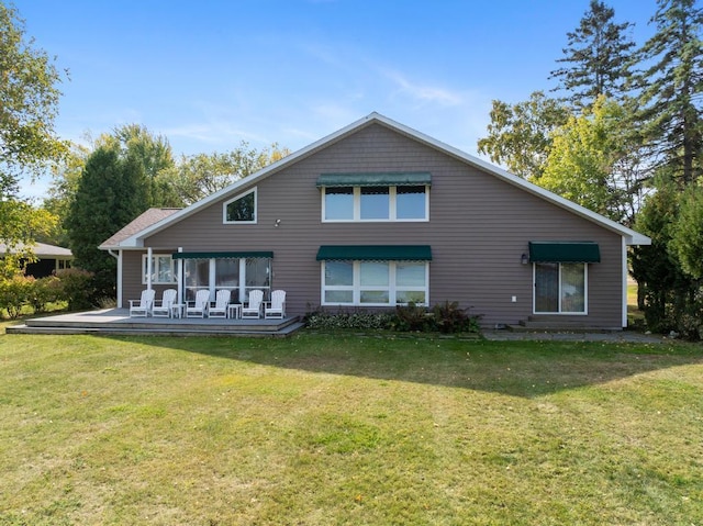 back of property featuring a yard and a deck