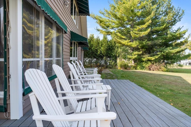 wooden deck featuring a yard