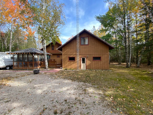 rear view of house with a lawn and a deck