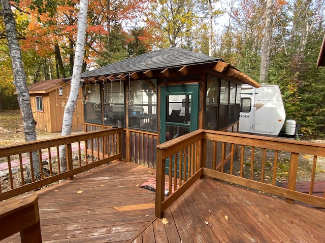 wooden deck featuring a sunroom