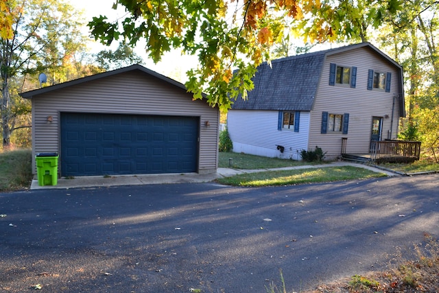 view of front of house with a garage and a deck