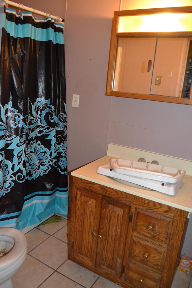 bathroom featuring vanity, toilet, and tile patterned flooring