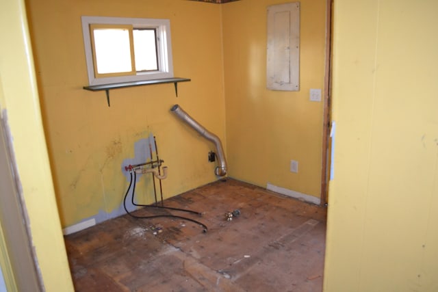 washroom featuring electric panel and hookup for a washing machine