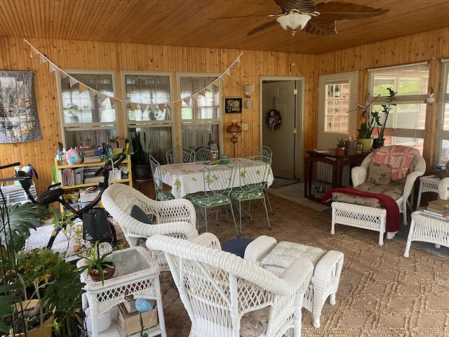 living room featuring wooden walls, ceiling fan, and wooden ceiling