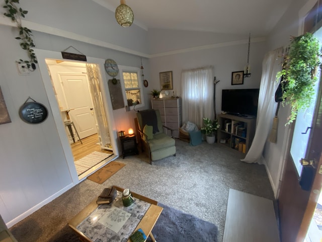 carpeted living room featuring vaulted ceiling