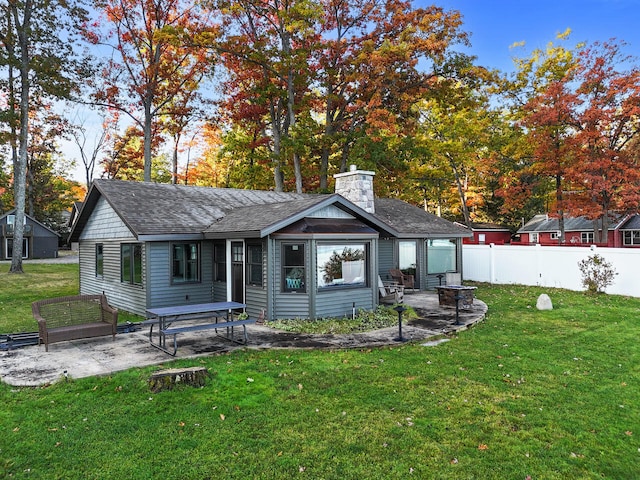 rear view of property with a patio area and a yard