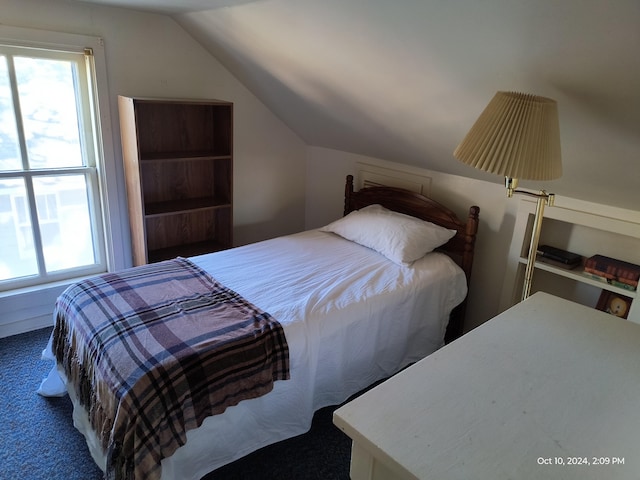 bedroom featuring carpet floors and lofted ceiling