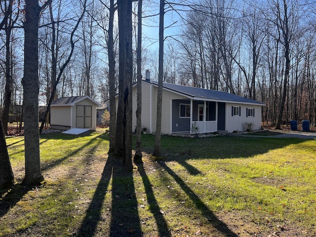 single story home with a front lawn and a storage shed