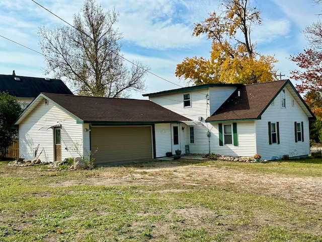 view of front of property featuring a garage and a front lawn