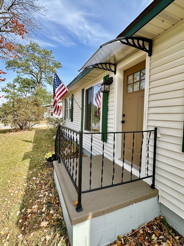 doorway to property with a yard