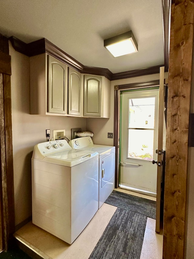 washroom featuring cabinets, independent washer and dryer, and crown molding