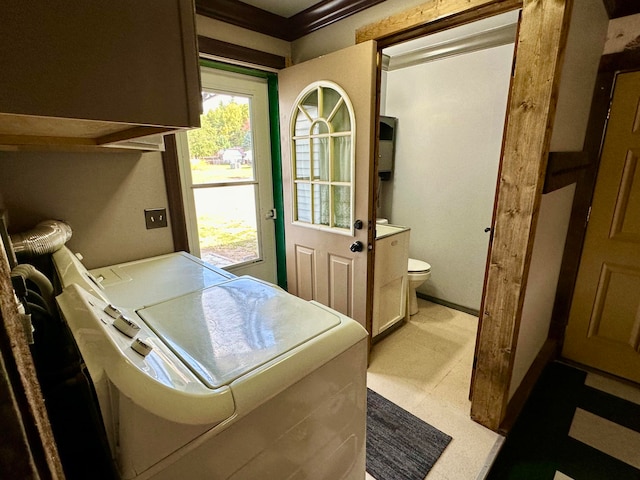 laundry area featuring crown molding and separate washer and dryer