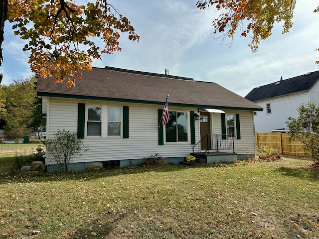 back of property featuring a lawn