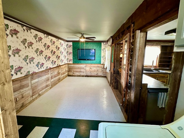 interior space with crown molding and ceiling fan