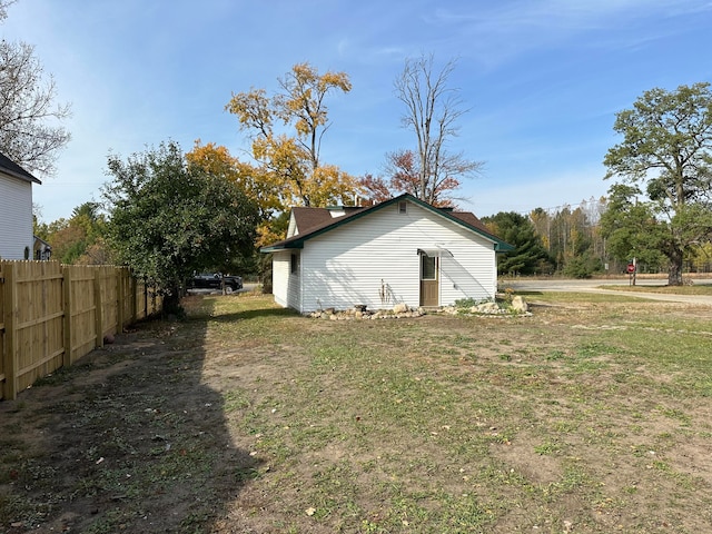 view of side of property with a yard