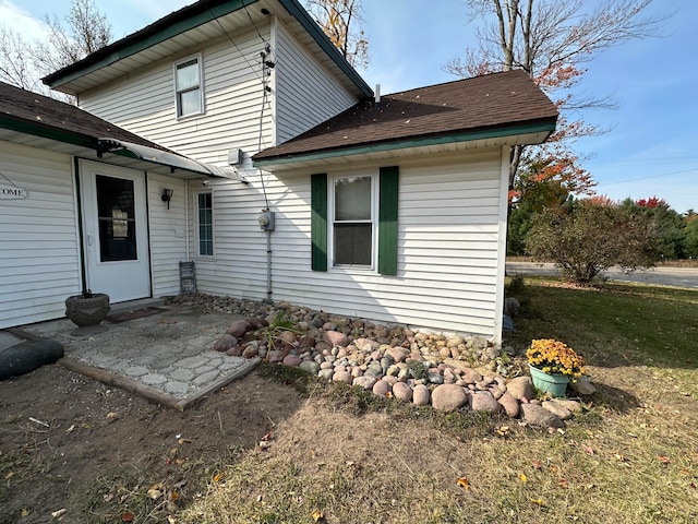 rear view of property featuring a patio area and a lawn