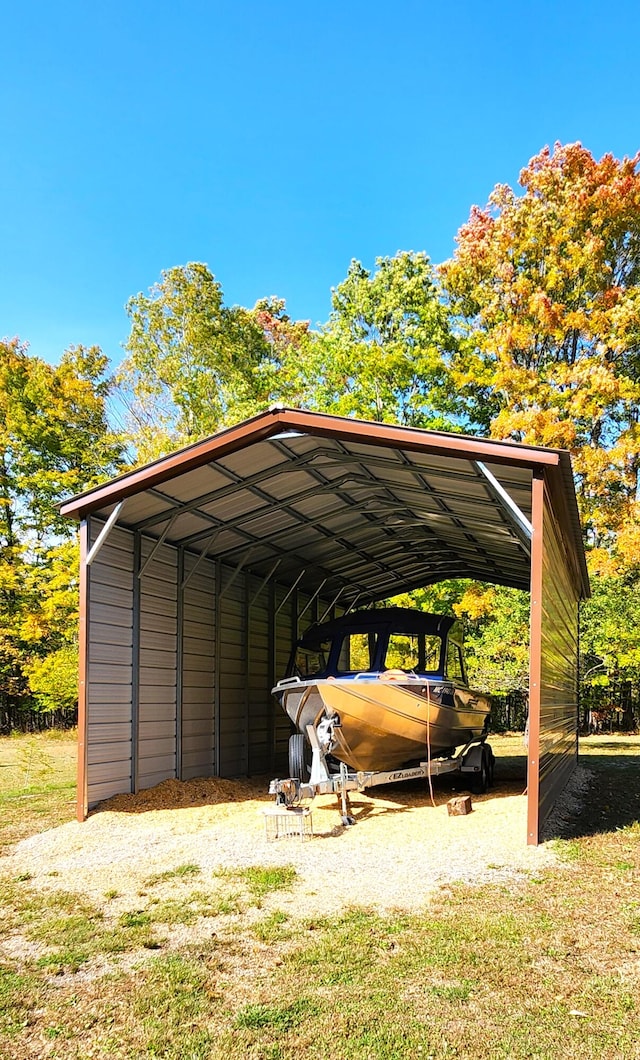 view of parking with a yard and a carport