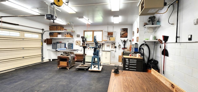 garage featuring a garage door opener and a workshop area