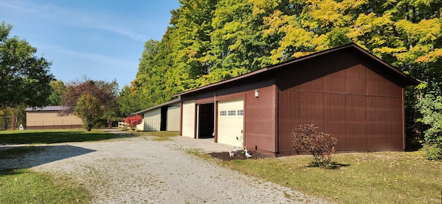 view of outbuilding featuring a garage and a lawn