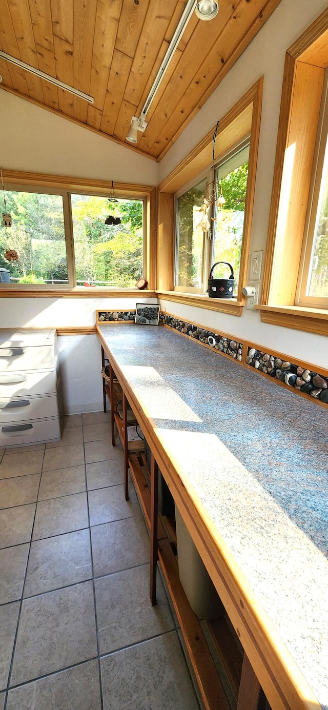 kitchen with wood ceiling, tile patterned flooring, and vaulted ceiling