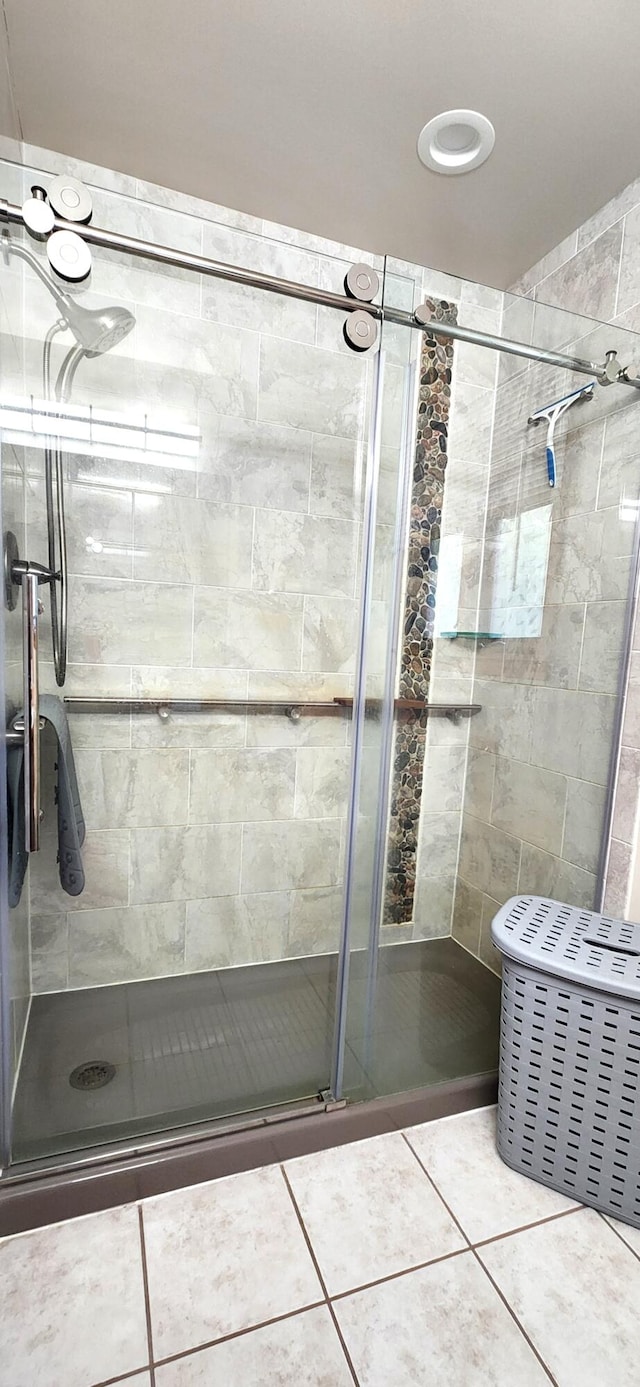 bathroom featuring tile patterned floors and a shower with door