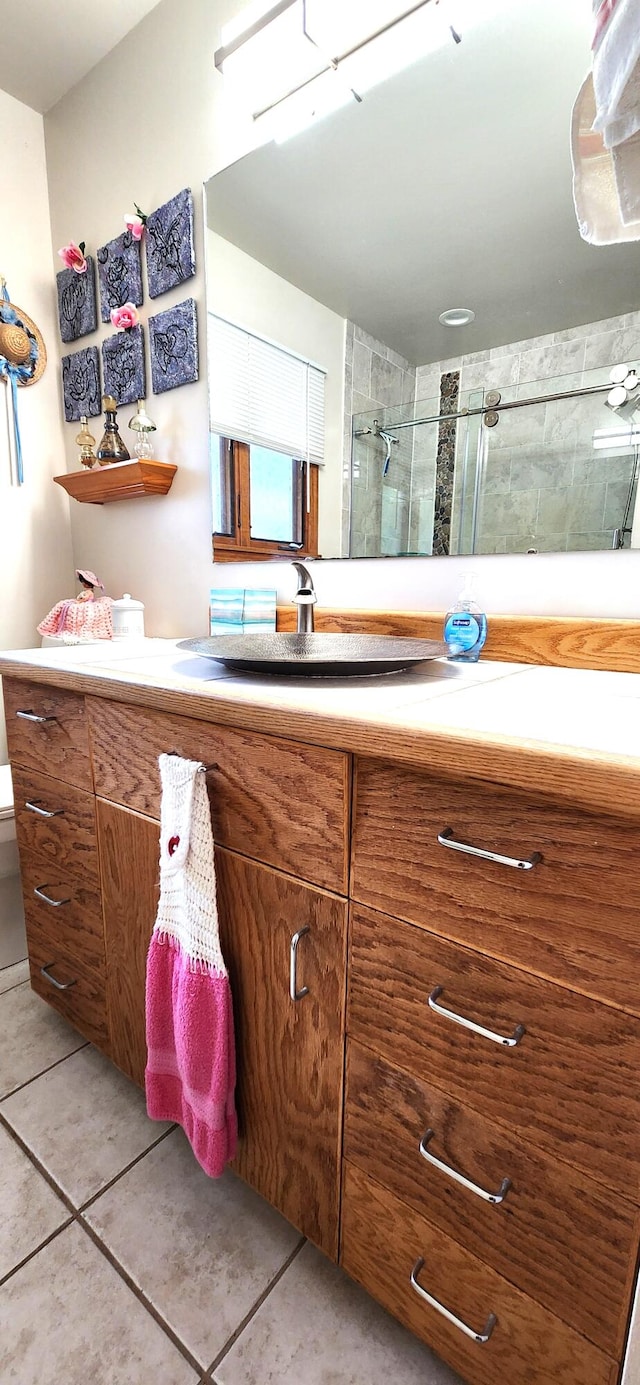 bathroom with vanity, toilet, tile patterned flooring, and an enclosed shower