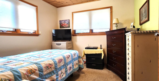 bedroom with light colored carpet and wooden ceiling