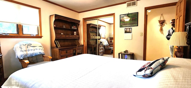 bedroom with a closet and ornamental molding