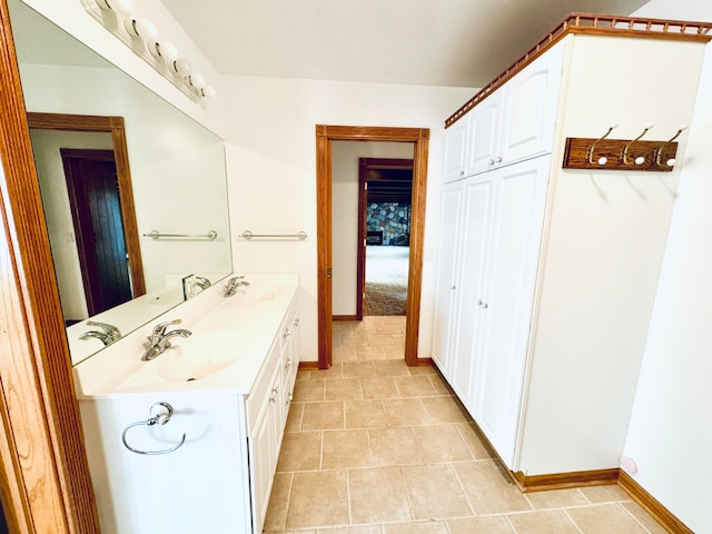 bathroom with tile patterned floors and vanity