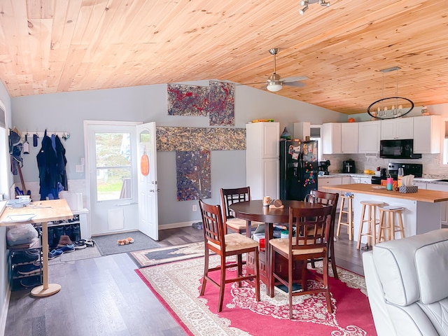 dining room with wood-type flooring, wood ceiling, vaulted ceiling, and ceiling fan