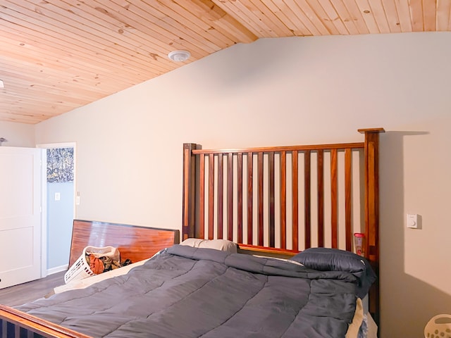 bedroom with vaulted ceiling with beams, wooden ceiling, and wood-type flooring