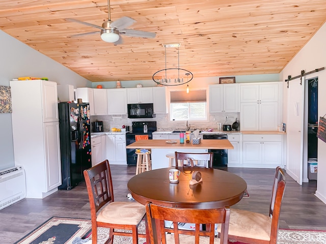 dining space with a barn door, ceiling fan, wood ceiling, vaulted ceiling, and dark hardwood / wood-style floors