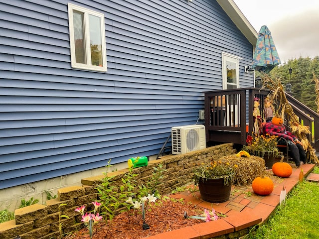 view of property exterior with ac unit and a deck