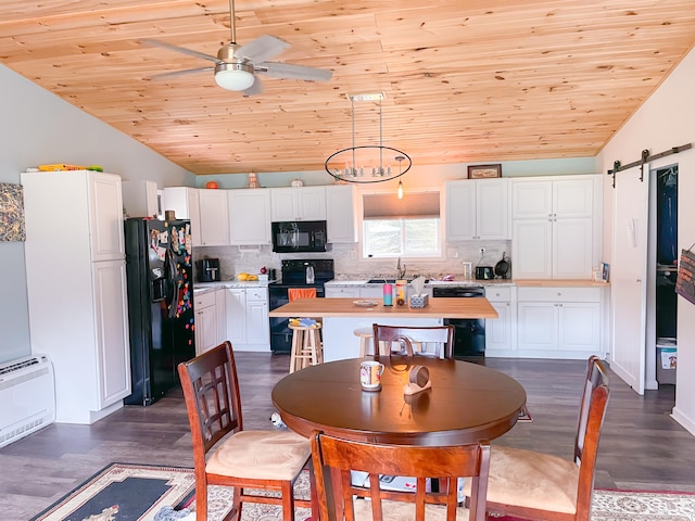 dining room featuring lofted ceiling, a barn door, wood ceiling, and dark hardwood / wood-style flooring