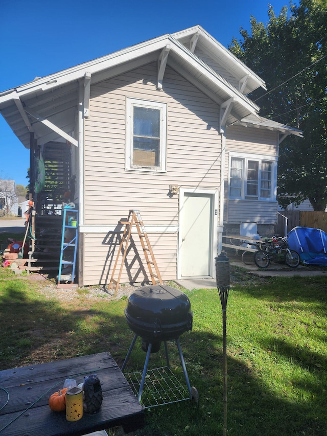 rear view of house featuring a lawn