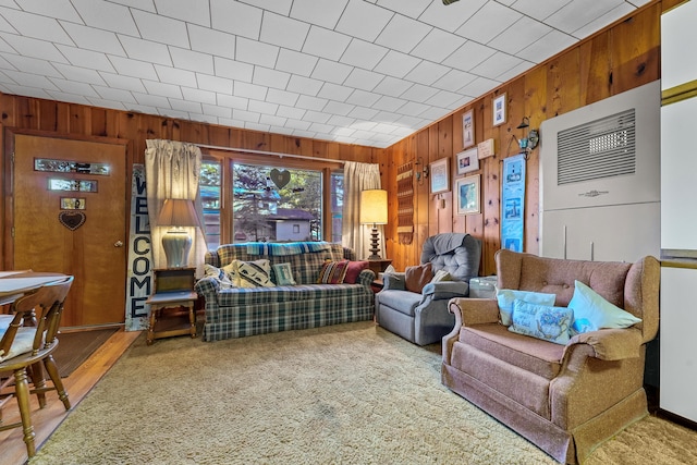 living room with wood walls and wood-type flooring