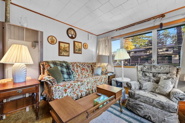 carpeted living room featuring ornamental molding