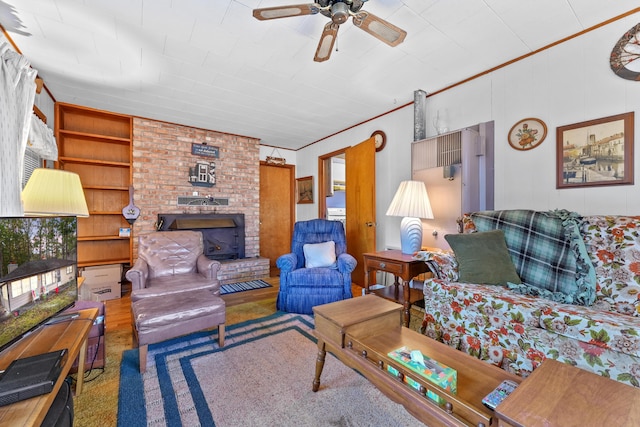 living room featuring ceiling fan, crown molding, hardwood / wood-style floors, and built in shelves