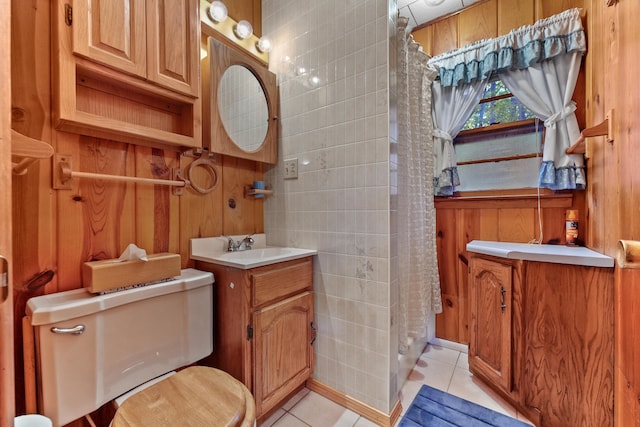 bathroom with vanity, tile patterned floors, wooden walls, and toilet