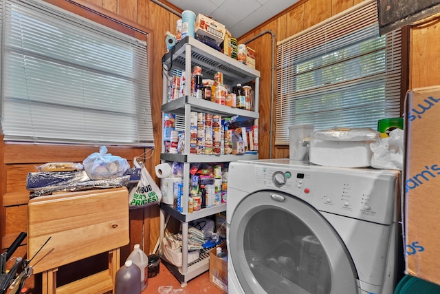 laundry area with wood walls and washer / clothes dryer