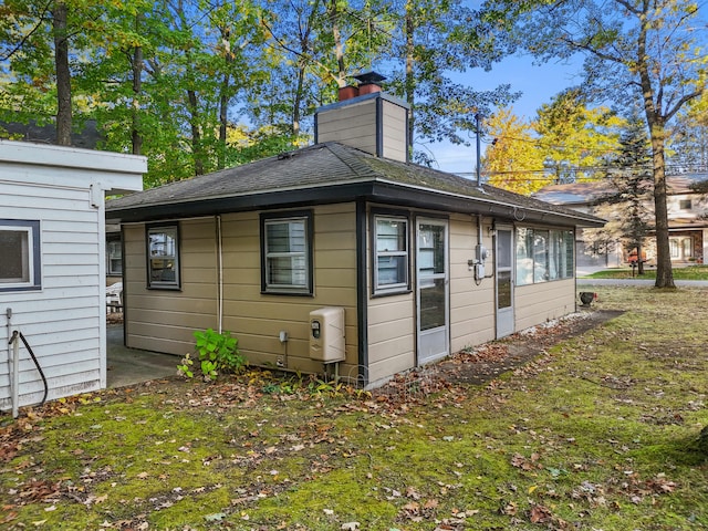 view of side of property with a yard