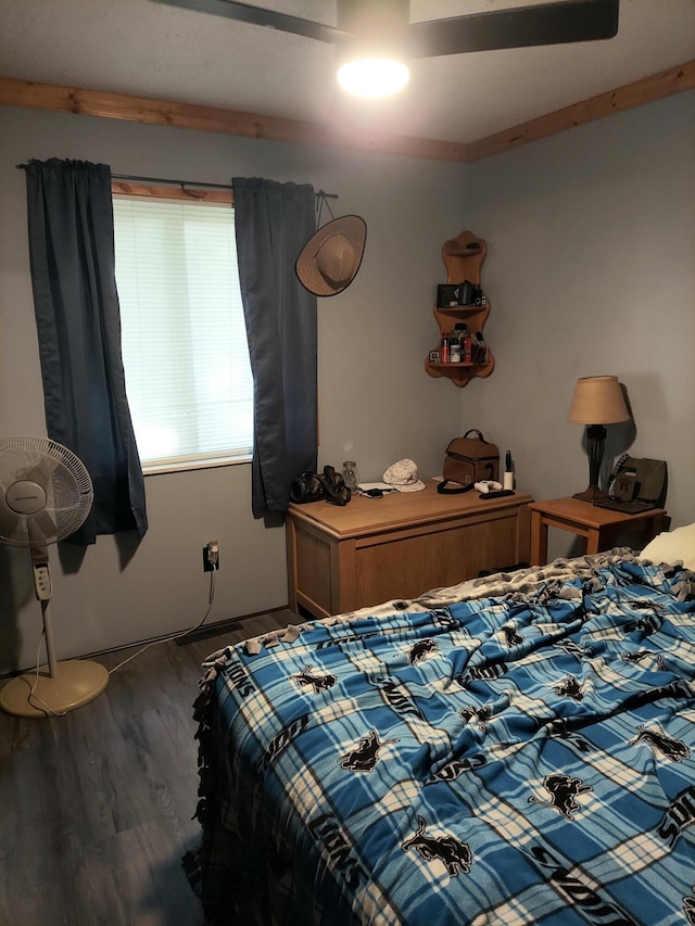 bedroom with dark wood-type flooring