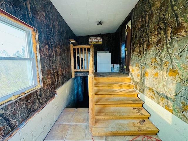 stairs with washer / dryer, tile patterned flooring, and plenty of natural light