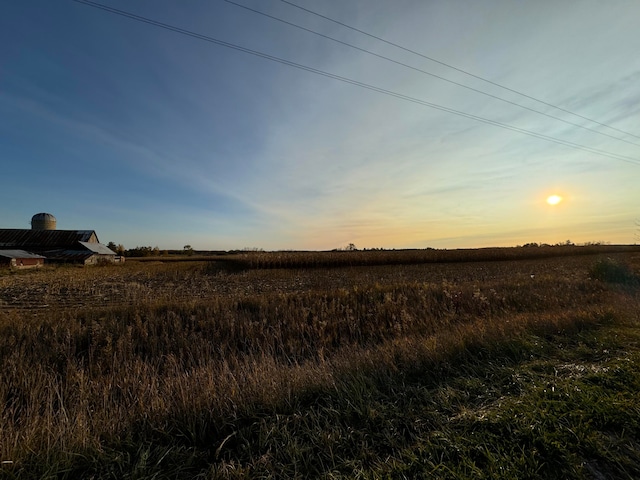 nature at dusk featuring a rural view