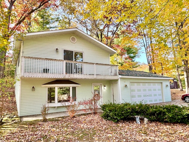 front of property with a balcony and a garage